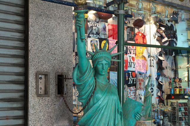 a small statue of liberty replica in front of a tourist shop